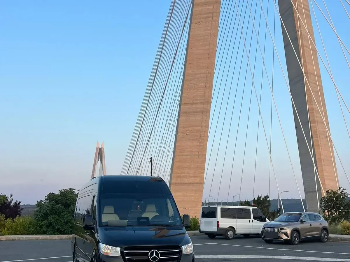 Black Mercedes Sprinter on a coast road